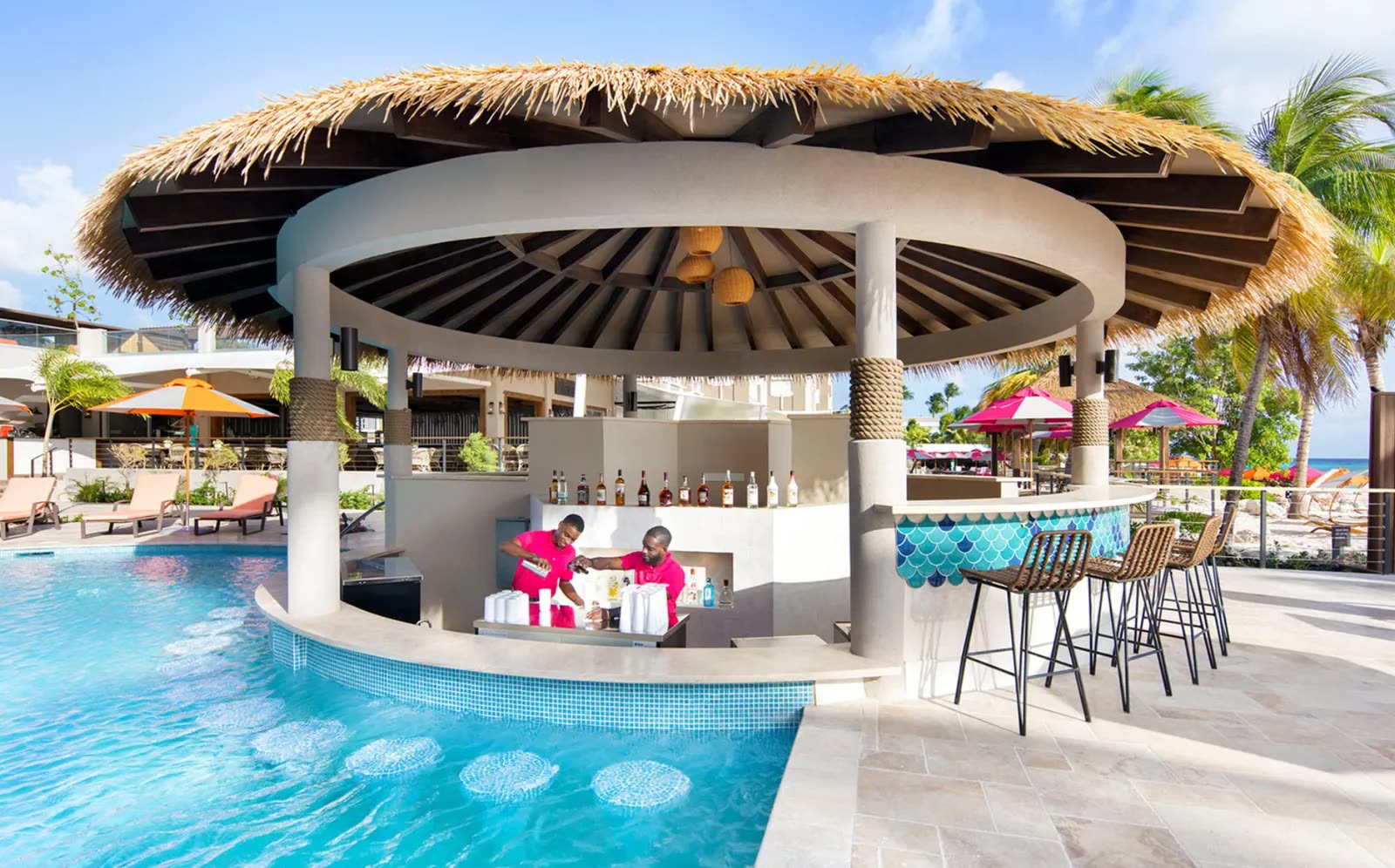 Reference: a circular swim-up bar with bartenders preparing drinks at a thatched palapa.